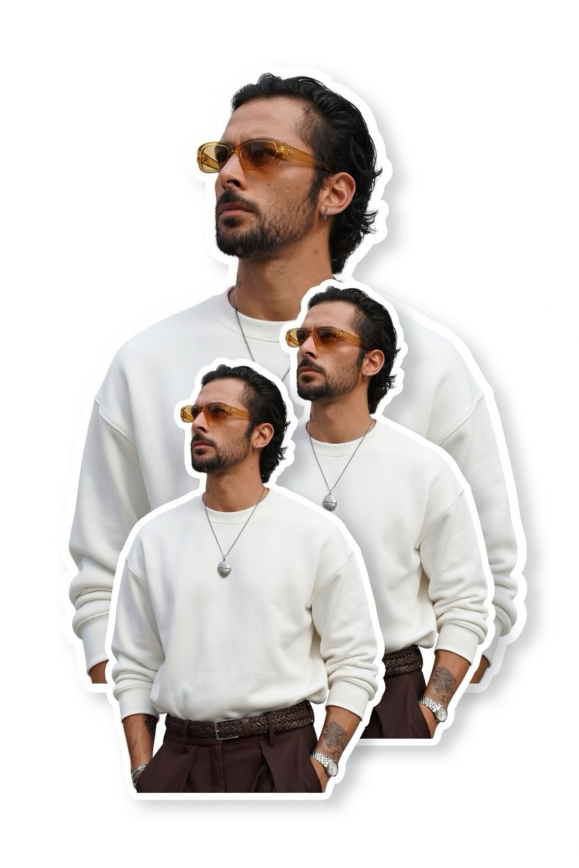 Portrait of Anil Sigma in a white sweatshirt, amber sunglasses and silver pendant necklace